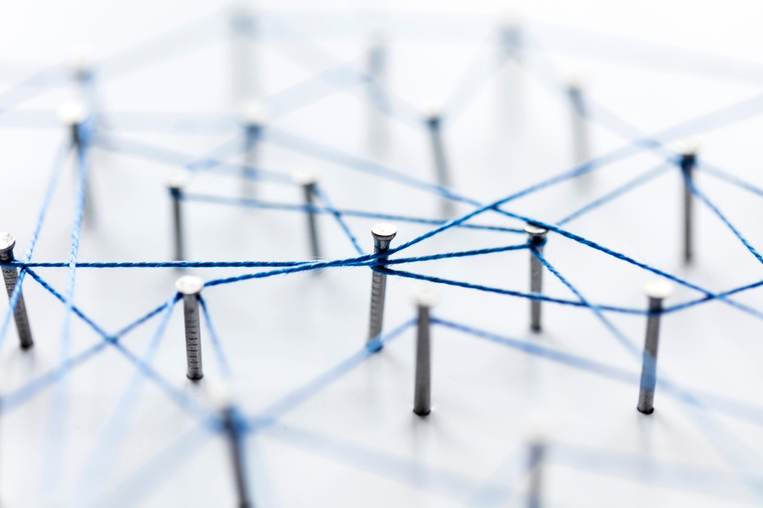 Blue threads connecting metal pins.